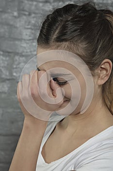 Woman struggling with nose pain, side view
