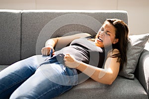 Woman Struggling With Tight Jeans