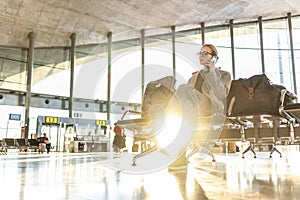 Woman stucked at airport terminal over flight cancellation,calling family, sitting in almost empty airport terminal due