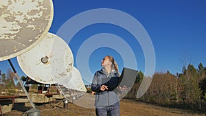 Woman student operator of institute of Solar Terrestrial Physics monitors communication equipment in notebook. Unique