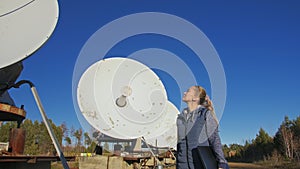 Woman student operator of institute of solar terrestrial physics monitors communication equipment in notebook. Unique