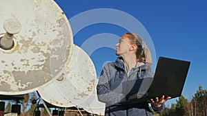 Woman student operator of institute of solar terrestrial physics monitors communication equipment in notebook. Unique