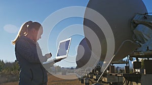 Woman student operator of institute of solar terrestrial physics monitors communication equipment in notebook. Unique