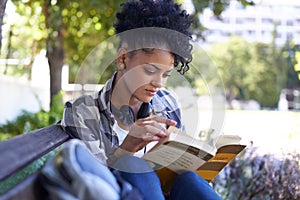 Woman, student and reading on bench with book for university study, learn education or relax. Female person, academic