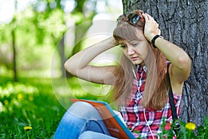 Woman student teenager woman clasped her hands behind her head. Fright, fear. Emotions when preparing for exams