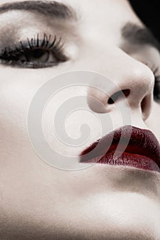 Woman, studio and face closeup in gothic makeup for beauty, cosmetics and zoom of skincare with dark aesthetic. Young