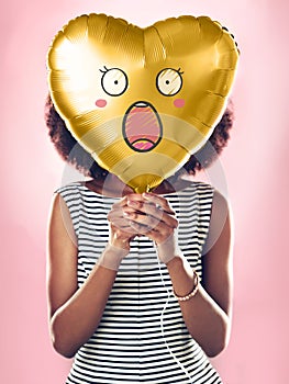 Woman, studio and wow on heart balloon for surprise on valentines day, isolated and pink background for love. Girl
