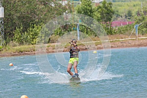 Woman study wakeboarding on a blue lake