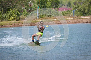 Woman study wakeboarding on a blue lake