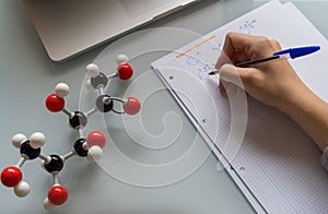 Woman studying chemistry with a molecular model of fructose