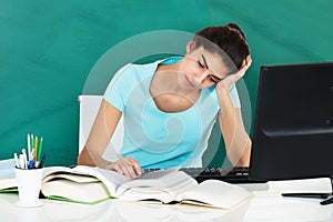Woman Studying On Desk In Classroom