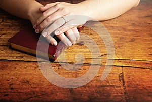 Woman Studying Her Bible at a Rustic Wood Table