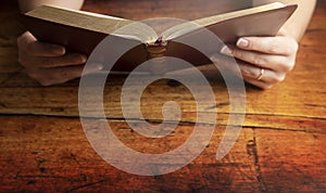 Woman Studying Her Bible at a Rustic Wood Table