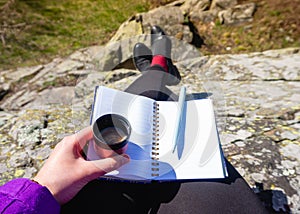 A woman studying in a park making notes