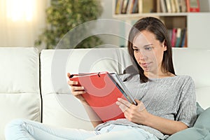 Woman studying reading notes sitting on a couch