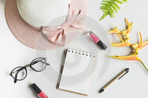 Woman stuff, makeup, flower with empty notepad