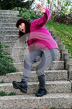 A woman stumbles on a staircase