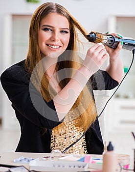 Woman styling her hair with hairdryer