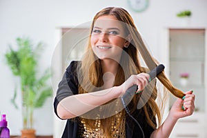 The woman styling her hair with hairdryer