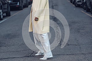 Woman in stylish outerwear walking on street