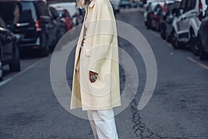 Woman in stylish outerwear walking on street