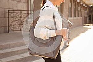 Woman with stylish shopper bag outdoors, closeup