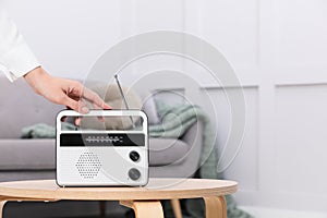 Woman with stylish white radio at home, closeup. Space for text