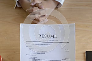 Woman submits job application, Interviewer reading a resume.