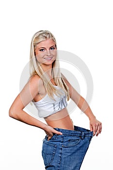 Woman after a successful diet with large trousers