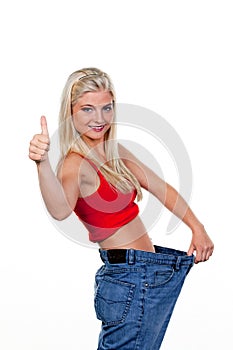Woman after a successful diet with large trousers