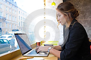 Woman successful website content creator using applications on laptop computer