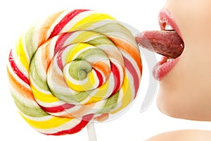 Woman sucking cute sweet candy closeup lips tongue isolated on w