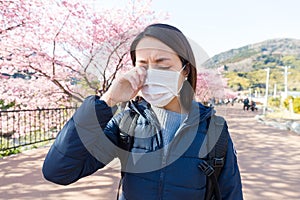 Woman suffer from allergy from pollen allergy at sakura season