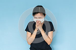 Woman suffer from sick on blue background.
