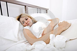 Woman suffering from abdomen pain in bed