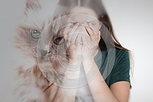 Woman suffering from ailurophobia on background. Irrational fear of cats