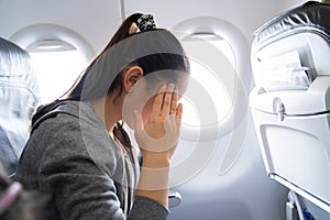 Woman Suffering From Airsickness In Airplane