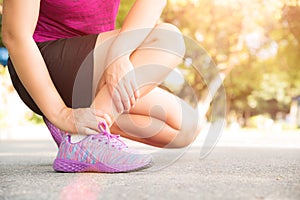Woman suffering from an ankle injury while exercising. Running s