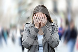 Woman suffering anxiety attack on city street