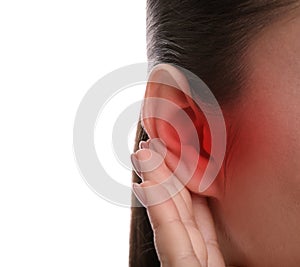 Woman suffering from ear pain on white background, closeup