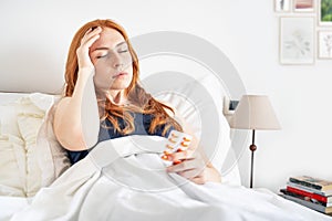 Woman suffering head pain taking medicine pills