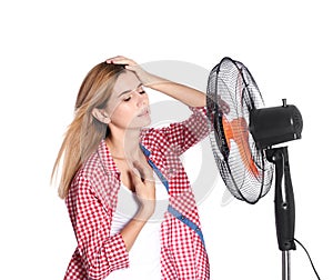 Woman suffering from heat in front of fan