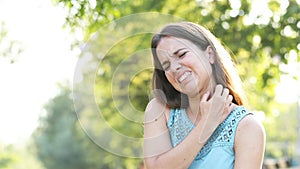 Woman suffering an itching scratching her neck