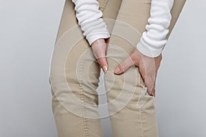 Woman suffering from knee pain or osteoarthrosis