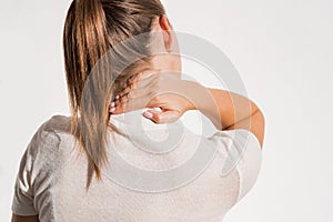 Woman suffering from neck pain or injury. Female massaging her neck