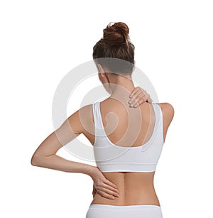 Woman suffering from pain in back on white background