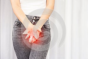 Woman suffering from pain, itchy crotch hand holding her burning  vaginal caused by bladder infections or cystitis photo