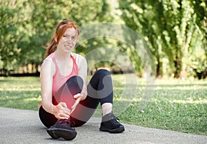 Woman suffering for a painful ankle injury during running training