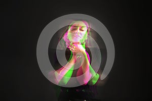 Woman suffering from paranoia on black background, glitch effect