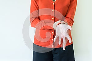 Woman suffering with parkinson`s disease symptoms on white background